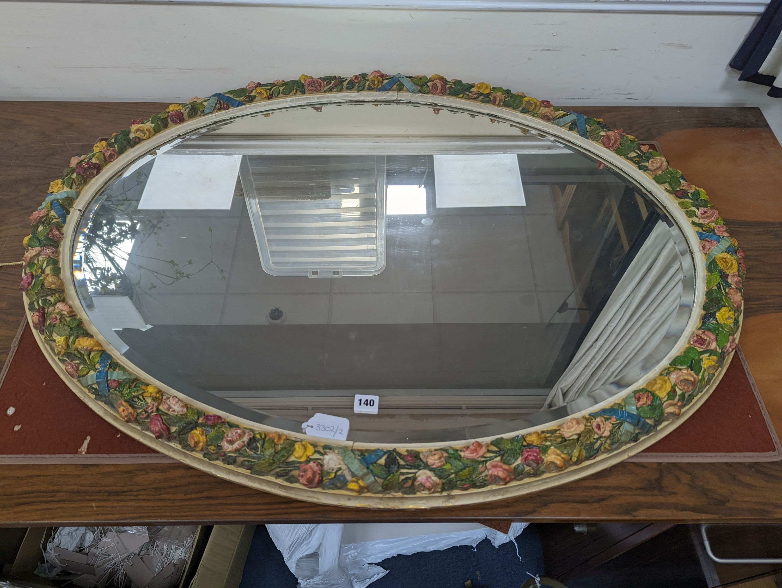 A large oval barbola framed mirror. W-115cm, H-85cm.